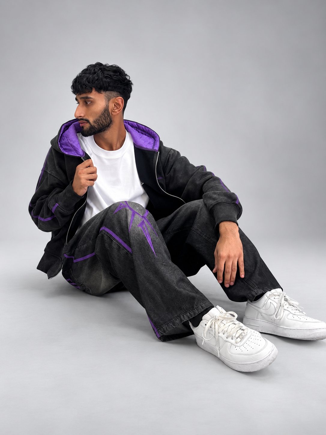 Model seated in the Drop 001 hoodie
